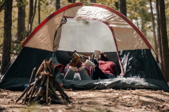 Camping gear with tent and campfire