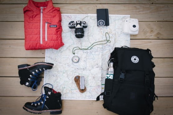Survival and camping equipment, boots, map, compass, backpack, jacket