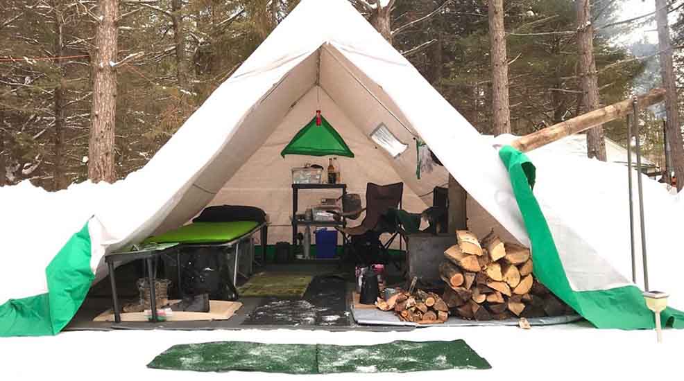 Hot tent camping setup with woodfire